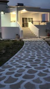 a white house with stairs and a walkway at Villa Helia in Kos +8 photos