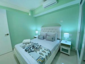 a bedroom with a bed with a blue light at AVENTURA SUITES playa LOS CORALES - great location! in Punta Cana