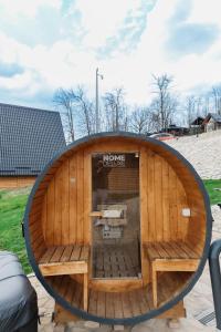 a large wooden sauna with two benches in it at Bungalow&Spa GIGIC I - Whirpool in Brčko