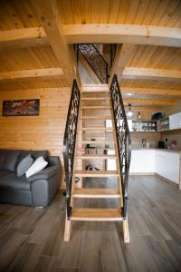 a spiral staircase in a room with a couch at Bungalow&Spa GIGIC I - Whirpool in Brčko