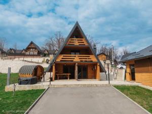 a large wooden house with a gambrel roof at Bungalow&Spa GIGIC I - Whirpool in Brčko