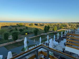 a view from the balcony of a resort with umbrellas at Hotel Amur in Corbu