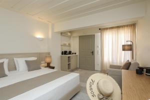 a bedroom with a large white bed and a couch at Agnadi Hotel in Agia Anna Naxos +74 photos