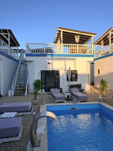 a villa with a swimming pool and a house at SUN Bungalow Costinești in Schitul