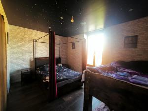 a room with two bunk beds and a window at La Chambres des Secrets in Vierzon