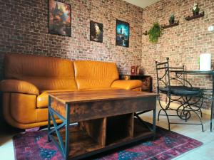 a living room with a couch and a table at La Chambres des Secrets in Vierzon