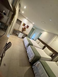 a large bedroom with two beds in it at HOTEL TERRA NATIVA in Alter do Chao