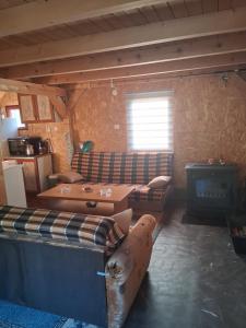 a living room with a couch and a stove at Vikendica Na Plivi E&M in Šipovo +27 photos