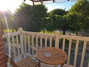 a wooden chair sitting on top of a balcony at Maison d' Adèlbraz in Voulaines