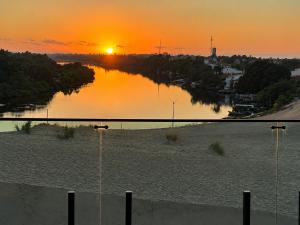 a view of a river with the sunset in the background at Bella Vista Hotel in Barreirinhas