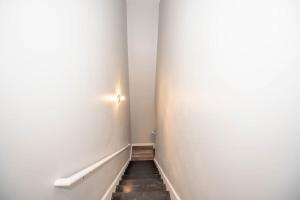 a hallway with a staircase with a light on the wall at Basic 4 bedrooms with 6 beds 15 min from downtown sleeps 9 Adults comfortably for Work crews and Large groups in Atlanta
