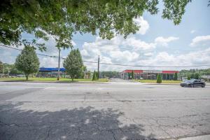 an empty parking lot with a car parked in front of a building at Basic 4 bedrooms with 6 beds 15 min from downtown sleeps 9 Adults comfortably for Work crews and Large groups in Atlanta