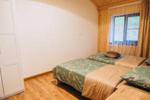 a bedroom with two beds and a window at Casa Monti in Ijevan
