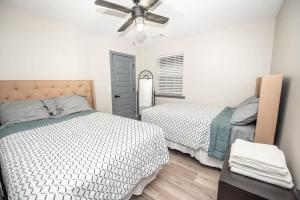 a bedroom with two beds and a ceiling fan at Spacious Dawsonville 4 bedrooms with 8 beds Sleeps 10 for Work crews and Large groups of friends and families in Dawsonville