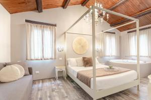a bedroom with a bed and a tub in a room at Villa Ca' Viola Rimini in Rimini