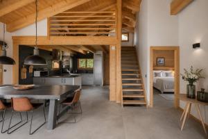 a kitchen and dining room with a table and a loft at Chalet Aramis in Riddes +16 photos