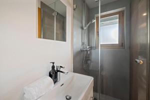 a bathroom with a sink and a shower at Chalet Aramis in Riddes