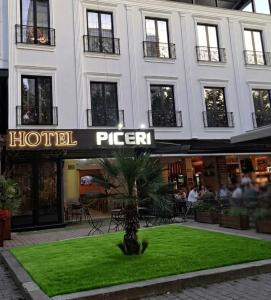 a hotel sign in front of a building at Hotel Shopi Residence in Elbasan