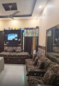 a room with couches and a tv and a couch at Army cuisine Dine in and LUXURY NIGHTLY STAY Kurali Punjab in Kūrāli