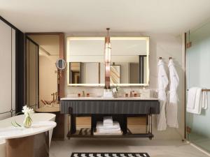 a bathroom with a sink and a large mirror at Fairmont Bangkok Sukhumvit in Bangkok +59 photos