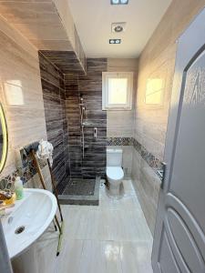 a bathroom with a toilet and a sink at Coronado Marina in Ain Sokhna +7 photos