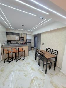 a kitchen with chairs and a table in a room at Coronado Marina in Ain Sokhna