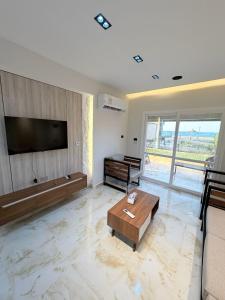 a living room with a flat screen tv on a wall at Coronado Marina in Ain Sokhna