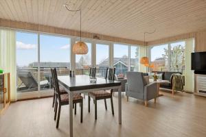 a dining room with a table and chairs and a couch at 30472-Odder-Ravnsager-20 in Dyngby