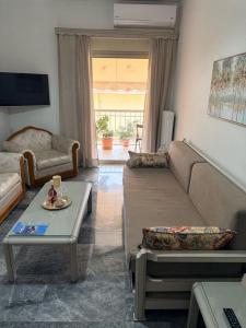 a living room with a couch and a table at KATERINA's House in Preveza