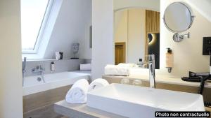 a bathroom with a sink and a tub and a mirror at Les Tanneurs in Namur +259 photos