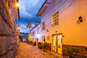 an alley in an old town at night at Hotel Monasterio del Inka Cusco in Cusco