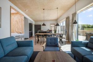 a living room with blue couches and a table at 30433-Saksild-Strand-Odder-Strandlodden-2 in Rude