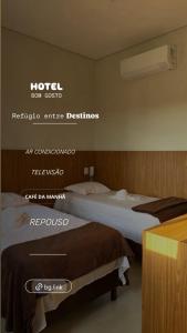 a hotel room with two beds and a sign for a room at Hotel Bom Gosto in Taiobeiras +1 photo