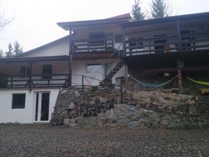 a house with a boat on top of a stone wall at Nautic Colibița in Colibiţa
