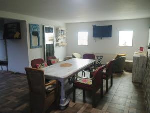 a dining room with a table and chairs at Nautic Colibița in Colibiţa