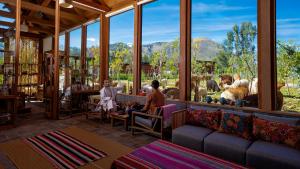 a group of people sitting in a room with windows at Viscas Hotel Luxury Resort & Spa in Pariahuanca