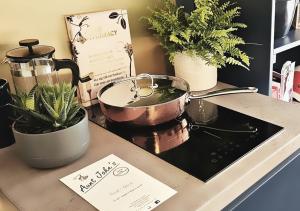 a counter with plants and a pot on a stove at Allihoop Ängby Aces in Stockholm