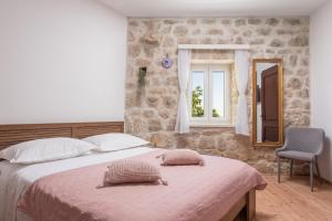 a bedroom with a large bed and a window at New Villa OLE, stone house, sea view, jacuzzi in Jesenice +61 photos