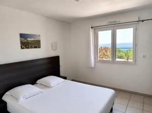 a bedroom with a white bed and a window at Apparthotel Résidence La Provence in Istres +51 photos