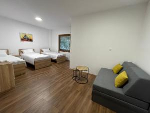 a living room with two beds and a couch at Gorna Kukja Apartments in Demir Hisar +13 photos