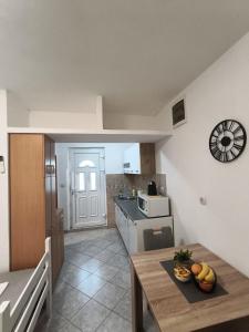 a small kitchen with a table and a counter top at SM Studio Apartman in Tivat