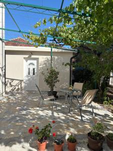 a patio with chairs and a table and some flowers at SM Studio Apartman in Tivat