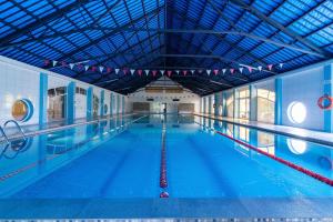 a large swimming pool with a large ceiling at Star-Dadaj Lake Camp in Barczewo