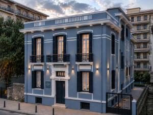 a blue building in front of a building at Villa Clio, a Luxury Collection in Thessaloniki