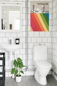 a bathroom with a toilet and a sink at Allihoop Ängby Aces in Stockholm