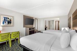 a hotel room with two beds and a desk at Best Western Plus Chesapeake Bay-Norfolk in Norfolk