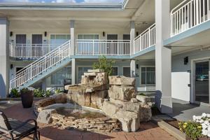 a building with a stone fountain in a courtyard at Best Western Plus Chesapeake Bay-Norfolk in Norfolk