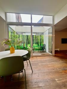 a dining room with a table and chairs and a large window at Studio 17 in Ghent