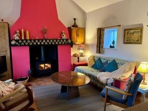 a living room with a couch and a fire place at Tornaroan Cottage in Ballycastle