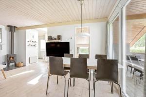 a kitchen and dining room with a table and chairs at FY132-Middelfart-Stjernevej-109 in Middelfart